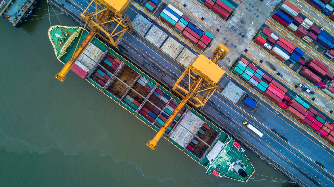 container-ship-carrying-container-for-import-and-export-aerial-view-business-logistic-and-freight-transportation-by-ship-in-open-sea