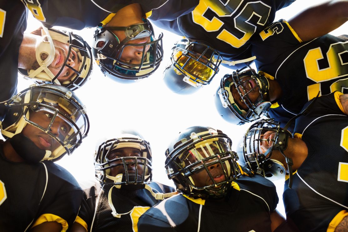 professional-football-players-huddled-while-in-time-out-during-game