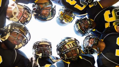 professional-football-players-huddled-while-in-time-out-during-game