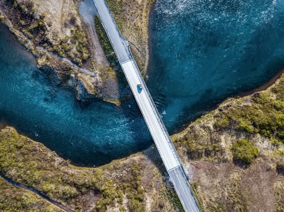 driving-on-a-bridge-over-deep-blue-water