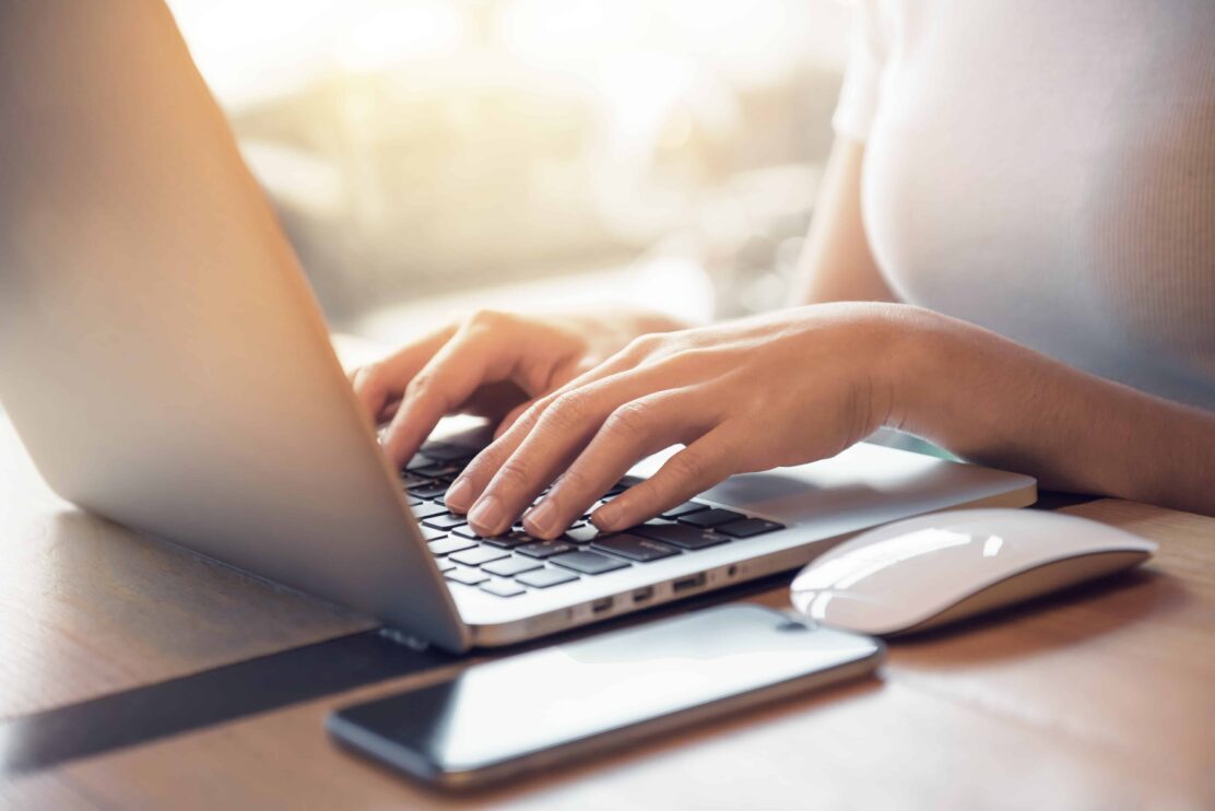 closeup-womans-hands-typing-on-a-laptop