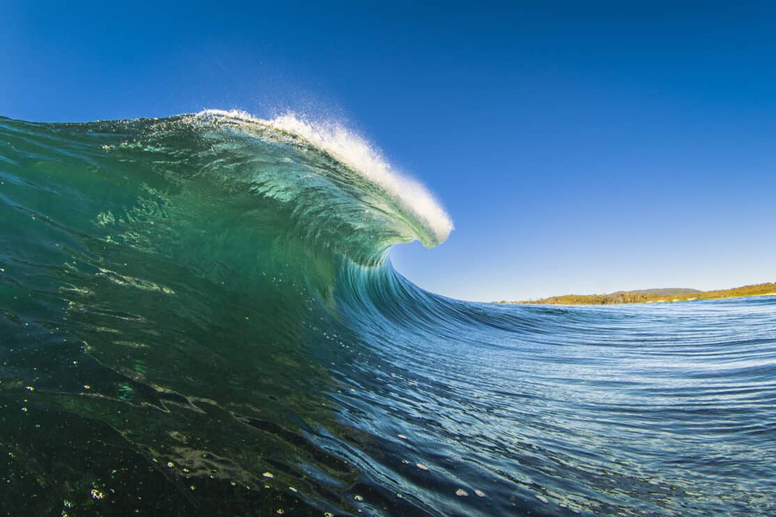 powerful-bright-green-ocean-wave-barrelling-on-a-shallow-reef-on-a-clear-day