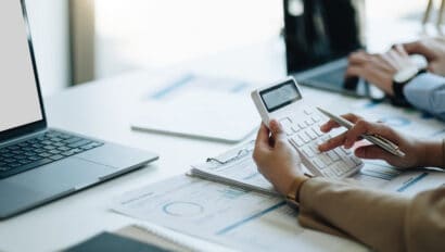 businesswoman-accountant-hand-working-on-calculator-to-calculate-financial-data-report-accountancy-document-and-laptop-computer-at-office-business-concept