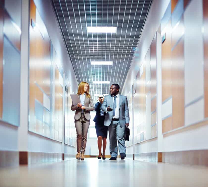 A group of people walking down a corridor.