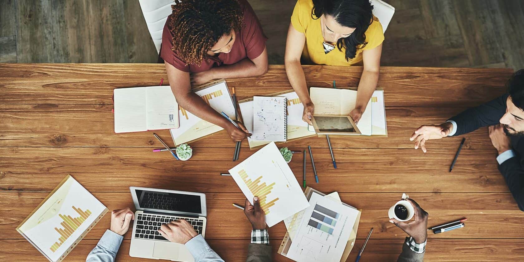 A group of people working at a table together.