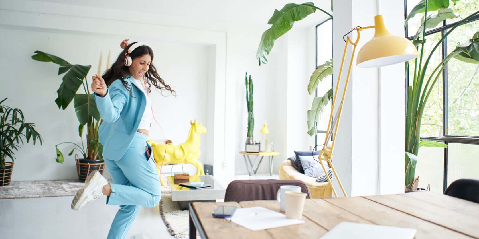 A woman dancing while wearing headphones.