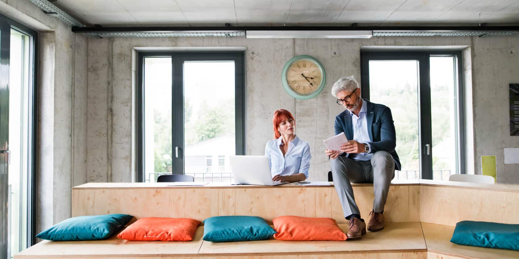 Two people working together in an office space.