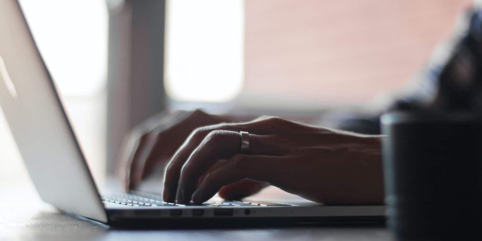 A person typing on a laptop.