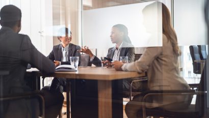 in-a-corporate-office-a-diverse-group-of-multi-ethnic-businesswomen-and-businessmen-gather-for-a-meeting-cheerful-participants-engage-in-lively-discussions-and-dialogue